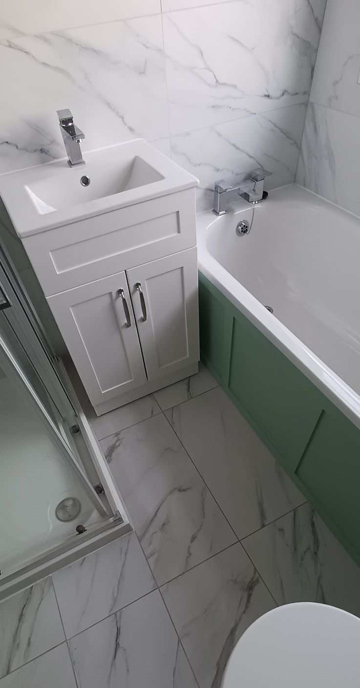 Bathroom, sage panelling and marble-effect tile